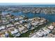 Expansive aerial view of a waterfront community with houses, boat docks, and serene canals leading to the open ocean at 627 Dundee Ln, Holmes Beach, FL 34217