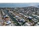 Wide aerial shot showcasing a waterfront residential area with private boat docks, lush landscaping, and beautiful canal views at 627 Dundee Ln, Holmes Beach, FL 34217