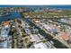 Scenic aerial view of waterfront homes along canal with a golf course in the distance at 627 Dundee Ln, Holmes Beach, FL 34217