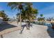 Backyard view with tropical trees, private dock, and canal access; perfect for boating and enjoying waterfront living at 627 Dundee Ln, Holmes Beach, FL 34217