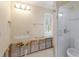 Bathroom features a glass enclosed shower, and a window for natural light at 627 Dundee Ln, Holmes Beach, FL 34217