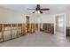 Large living room with tile floor and ceiling fan, ready to be updated at 627 Dundee Ln, Holmes Beach, FL 34217