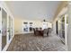 Covered patio featuring brick flooring, a ceiling fan, and a dining set at 627 Dundee Ln, Holmes Beach, FL 34217