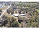 Drone shot of property featuring two buildings surrounded by trees in a peaceful setting at 6521 121 St E Ave, Parrish, FL 34219