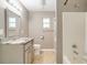 Neutral toned bathroom featuring a single vanity, and a shower-tub combo with a glass door at 6521 121 St E Ave, Parrish, FL 34219