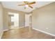 Bedroom with wood-look tile flooring, a ceiling fan, and a closet at 6521 121 St E Ave, Parrish, FL 34219