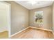 Cozy bedroom featuring a window with blinds, closet and wood-look tile floors at 6521 121 St E Ave, Parrish, FL 34219