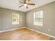 Bedroom with wood-look tile flooring and bright, natural light at 6521 121 St E Ave, Parrish, FL 34219