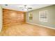 Large, empty bedroom featuring wood floors, a feature wall, and natural light from two windows at 6521 121 St E Ave, Parrish, FL 34219