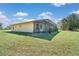 Exterior angle of home with screened in porch and landscaping at 6521 121 St E Ave, Parrish, FL 34219