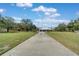 Spacious lot with a long concrete driveway leading to a home with a three-car garage at 6521 121 St E Ave, Parrish, FL 34219