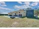 Rear exterior of home with sign, storage container, and bikes at 6521 121 St E Ave, Parrish, FL 34219