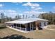 Exterior view of home with a large screened-in porch at 6521 121 St E Ave, Parrish, FL 34219