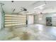 Spacious garage with automatic door, lighting, and storage shelving at 6521 121 St E Ave, Parrish, FL 34219