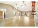 Bright and airy living room with an accent wall, fans, and tiled floors at 6521 121 St E Ave, Parrish, FL 34219