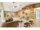 Modern living room with wood plank accent wall, ceiling fans, and tile floors at 6521 121 St E Ave, Parrish, FL 34219