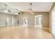 Bright, open-concept living room featuring tile floors, ceiling fans, and views into the kitchen at 6521 121 St E Ave, Parrish, FL 34219