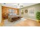 Main bedroom suite featuring modern decor, hardwood floors, wood accent wall, and natural light at 6521 121 St E Ave, Parrish, FL 34219