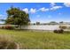 Expansive backyard with lush green grass, mature tree, and white vinyl fence offering privacy and space at 6912 Playa Bella Dr, Bradenton, FL 34209