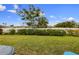 Spacious, grassy backyard with mature trees and lush landscaping, great for outdoor activities and relaxation at 6912 Playa Bella Dr, Bradenton, FL 34209