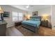 Cozy bedroom featuring a grey bed frame and side tables, plus a decorative area rug on hardwood floors at 6912 Playa Bella Dr, Bradenton, FL 34209