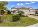 Charming home boasts a beautifully landscaped front yard, an arched entryway, and a two-car garage at 6912 Playa Bella Dr, Bradenton, FL 34209