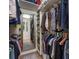 Large walk-in closet featuring an abundance of hanging storage and shelving with a built-in mirror at 6912 Playa Bella Dr, Bradenton, FL 34209