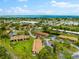 Wide aerial showcasing the community and waterfront at 7 Quails Run Blvd # 9, Englewood, FL 34223