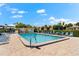 Inviting community pool with lounge chairs and patio area at 7 Quails Run Blvd # 9, Englewood, FL 34223