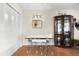 Bright dining area with a table, chairs, and a display cabinet at 7 Quails Run Blvd # 9, Englewood, FL 34223