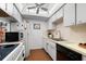 Efficient galley kitchen, white cabinets, and modern appliances at 7 Quails Run Blvd # 9, Englewood, FL 34223