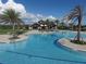 Stunning aerial view of the pool with lounge areas, palm trees, and community center at 7103 Westhill Ct, Lakewood Ranch, FL 34202