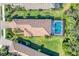 Aerial shot of a home with a tile roof, landscaped yard, and screened-in pool at 7103 Westhill Ct, Lakewood Ranch, FL 34202