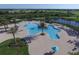 Overhead shot of a community pool with sun loungers and mature palm trees at 7103 Westhill Ct, Lakewood Ranch, FL 34202