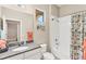 Bright bathroom featuring a granite countertop vanity and shower-tub combo at 7103 Westhill Ct, Lakewood Ranch, FL 34202