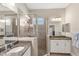 Bathroom features a spacious shower with glass door, dual sinks and granite countertop at 7103 Westhill Ct, Lakewood Ranch, FL 34202