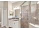 Well-lit bathroom featuring a granite countertop vanity and glass-enclosed tiled shower at 7103 Westhill Ct, Lakewood Ranch, FL 34202