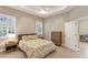 Spacious bedroom with tray ceiling, plantation shutters, and access to ensuite bathroom at 7103 Westhill Ct, Lakewood Ranch, FL 34202