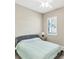 Cozy bedroom featuring a neutral color palette, shuttered window, and ceiling fan at 7103 Westhill Ct, Lakewood Ranch, FL 34202