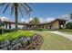 Clubhouse entrance with tropical landscaping, walkway, and covered portico at 7103 Westhill Ct, Lakewood Ranch, FL 34202