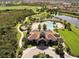 Aerial view of the community center with pool, lush grounds, and beautiful landscaping at 7103 Westhill Ct, Lakewood Ranch, FL 34202