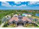 Stunning aerial perspective of the community center with a resort-style pool surrounded by tropical landscaping and seating at 7103 Westhill Ct, Lakewood Ranch, FL 34202