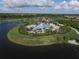 Aerial view of the community pool and amenities featuring palm trees and a lake at 7103 Westhill Ct, Lakewood Ranch, FL 34202