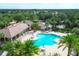 Resort-style pool area, complete with lounge chairs, umbrellas, and poolside pavilion surrounded by palm trees at 7103 Westhill Ct, Lakewood Ranch, FL 34202