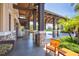 Covered walkway with stone pillars, wood beams, and tropical plants at 7103 Westhill Ct, Lakewood Ranch, FL 34202