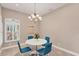 Cozy dining area with modern chandelier and large window with custom shutters at 7103 Westhill Ct, Lakewood Ranch, FL 34202