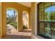 Inviting entrance featuring arched columns, brick walkway, and lush landscaping at 7103 Westhill Ct, Lakewood Ranch, FL 34202