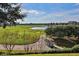 Picturesque golf course view with rolling green hills, a pond, and mature trees creating a tranquil setting at 7103 Westhill Ct, Lakewood Ranch, FL 34202