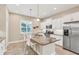 Well-lit kitchen with an island, stainless steel appliances, and ample cabinet space at 7103 Westhill Ct, Lakewood Ranch, FL 34202