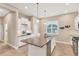 Spacious kitchen featuring granite countertops, white cabinets, and modern lighting fixtures at 7103 Westhill Ct, Lakewood Ranch, FL 34202